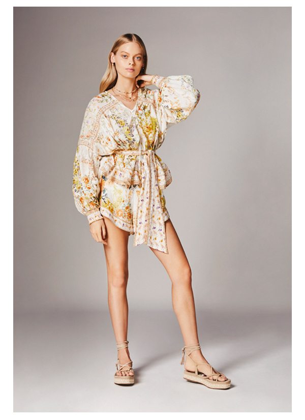 Model wearing blouse and shorts