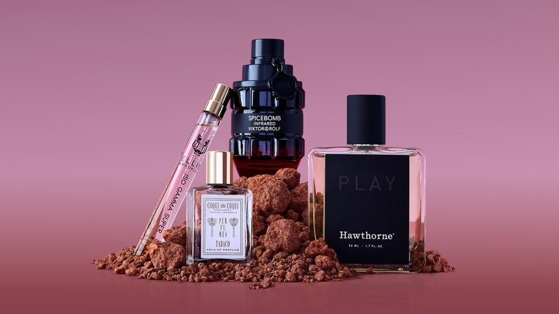 Viktor & Rolf Spicebomb Infrared Eau de Toilette, Hawthorne Wild and Botanic Play Cologne, Ellis Brooklyn ISO GAMMA SUPER Eau de Parfum Travel Spray, and Coqui Coqui Tabaco Eau de Parfum on a pink background GQ Limited-Edition Fragrance Box 2022