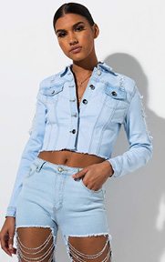 The Catch and Release Chain Link Distressed Denim Jacket is a long sleeved, light wash jean jacket complete with allover distressed detailing, a folded collar, button down front and chain link detailing on the back of the piece.