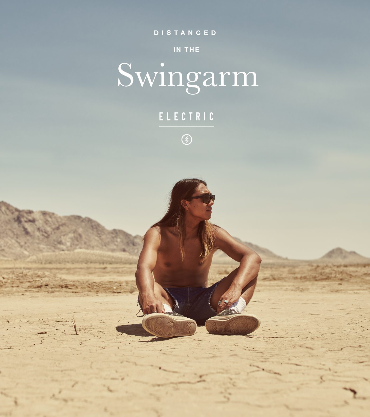 Man Sitting in the desert wearing Swingarm