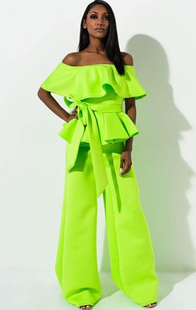 Run The World Off The Shoulder Jumpsuit is a scuba knit, statement making jumpsuit complete with a ruffled, off the shoulder neckline, attached wide leg pants, slip on fit and matching fabric tie belt.