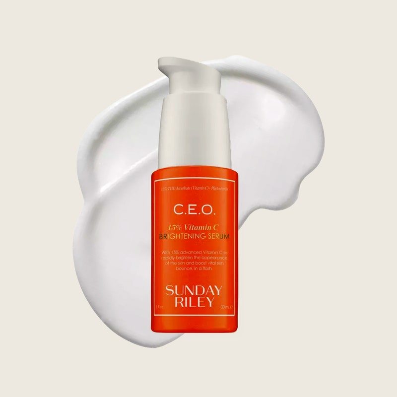 The orange bottle of skin-care serum from Sunday Riley on a beige background