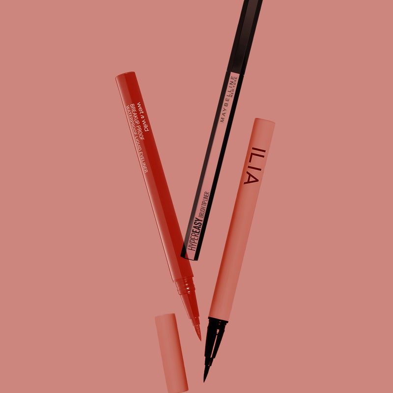 Different eyeliners from Maybelline New York, Ilia, and Wet n' Wild on a red background