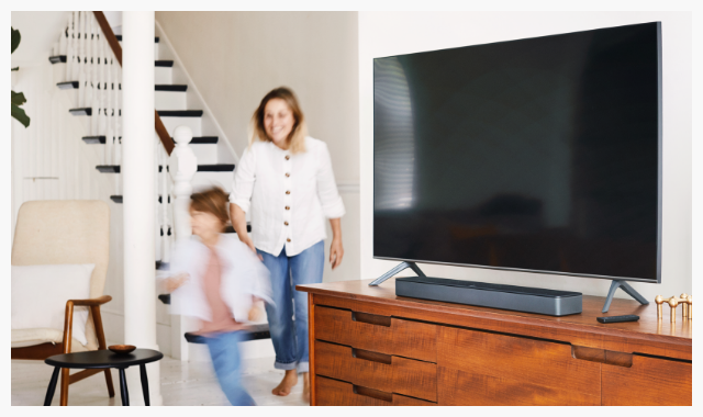 Family next to their Bose Soundbar 300