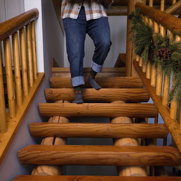 Darn It - a sock-wearer walks down wooden steps, accidentally dropping an armful of ornaments