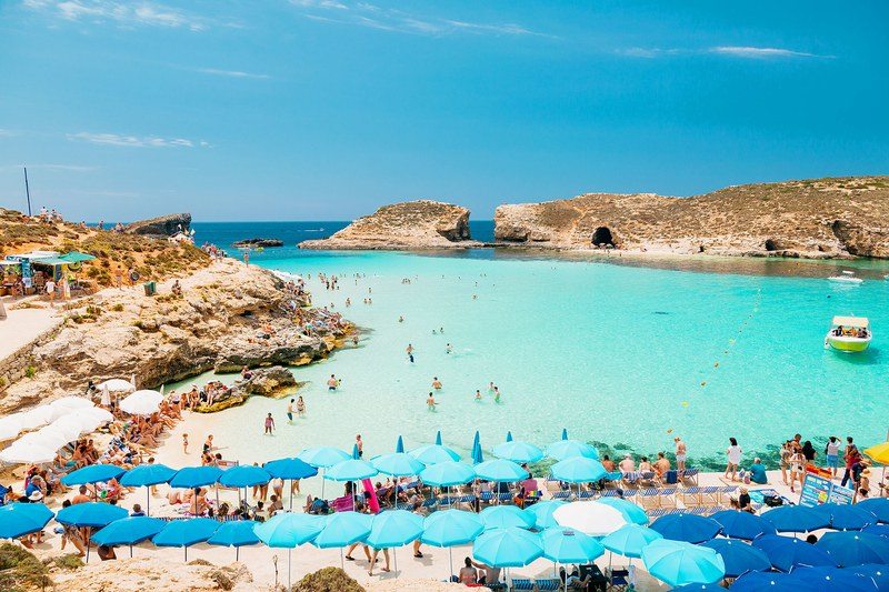 people and boats in the blue lagoon 