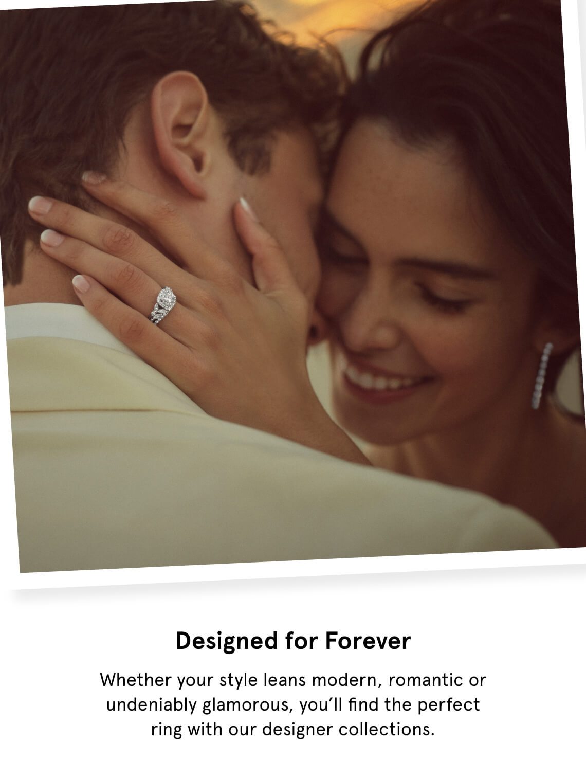 Designed for Forever | Polaroid photograph of couple on a beach facing each other cheeks to cheek as the woman smiles and holds the man's face showing a diamond engagement ring