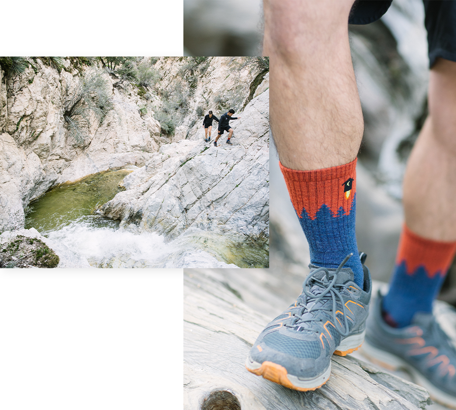 A pair of friends trekking around a rocky waterway, and they're wearing our playful Number 2 socks