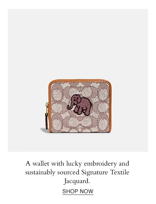 A wallet with lucky embroidery and sustainably sourced Signature Textile Jacquard. SHOP NOW