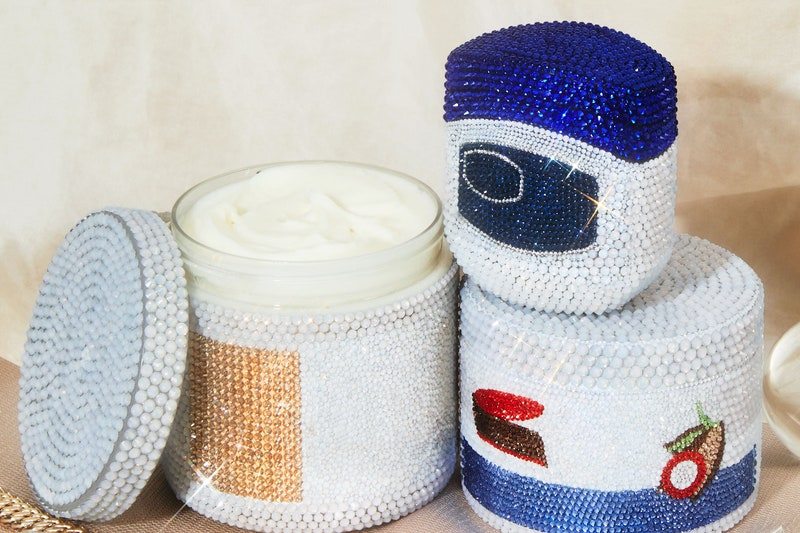 Close shot of rhinestoned vaseline, shea butter and cocoa butter containers 