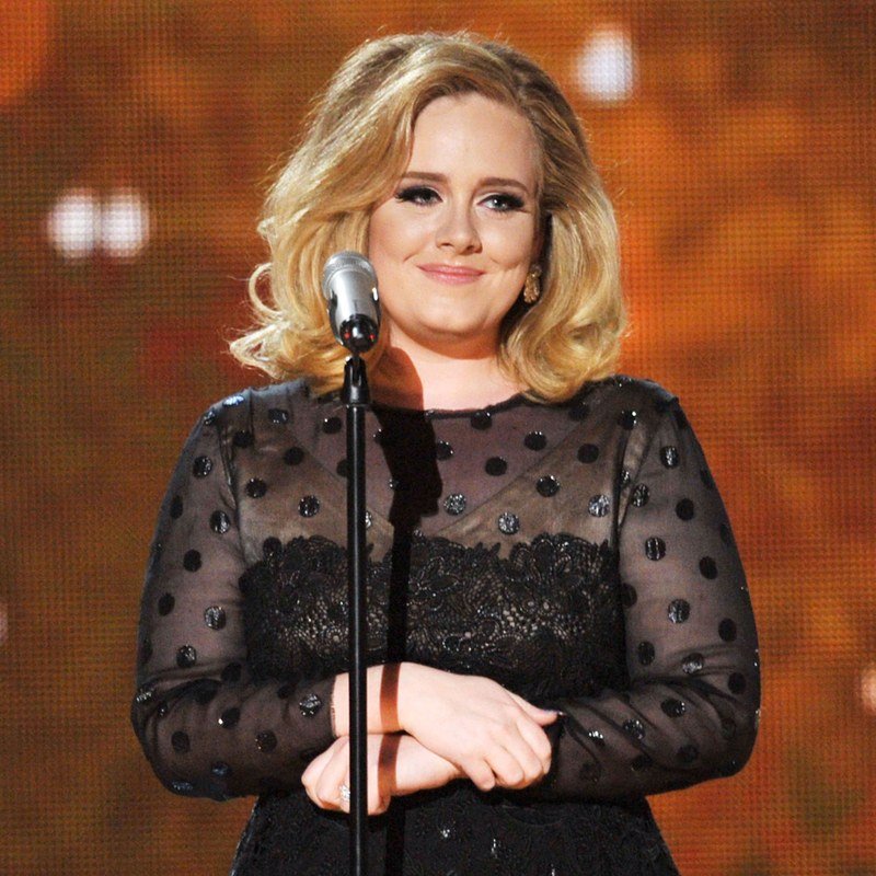 Adele onstage in a black dress