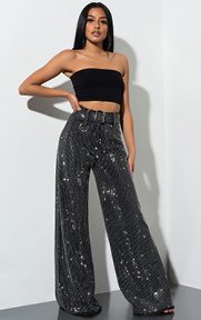 We Lit Rhinestone Trousers are a super wide leg, statement making pant complete with a high waist hem, matching tie belt, and an allover super shimmery rhinestone pinstripe pattern.