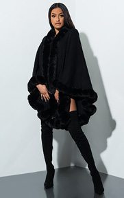 Boujee Faux Fur Poncho is an oversized, one size fits all, soft knit poncho complete with a flowing, draped design and fuzzy, faux fur trim detailing the hem of the piece.