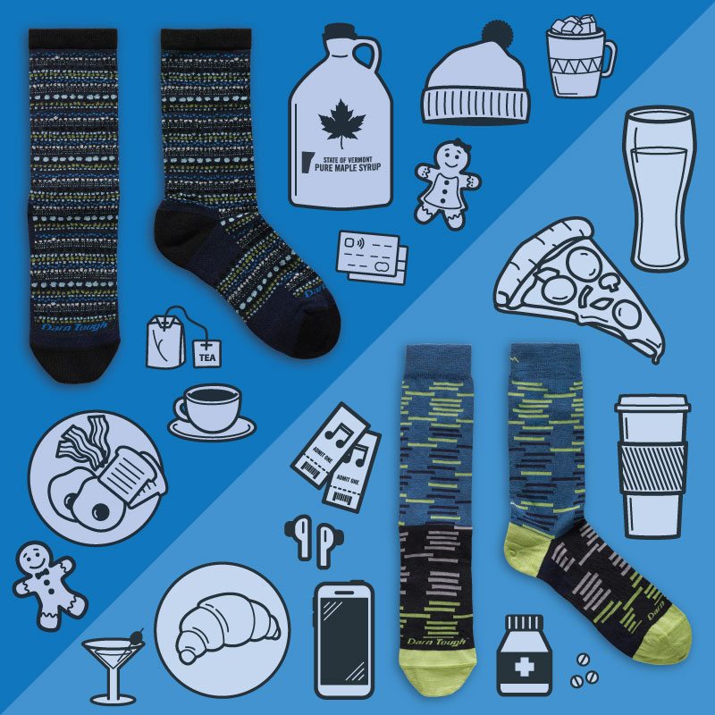 Two pairs of socks laying down on two shades of blue background surrounded by illustrated items that relate to festive random stuff.