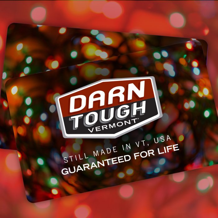 Shop Gift Cards - close up of Darn Tough gift card surrounded by holiday decorations