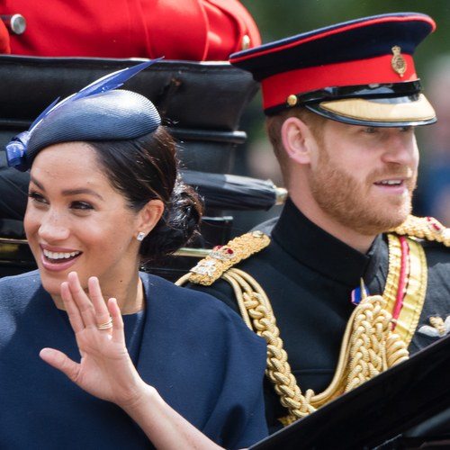 Prince Harry, Duke of Sussex and Meghan, Duchess of Sussex ride by carriage down the Mall during Trooping The Colour