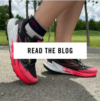 Read the blog - a runner wearing original Darn Tough run socks and black and pink sneakers