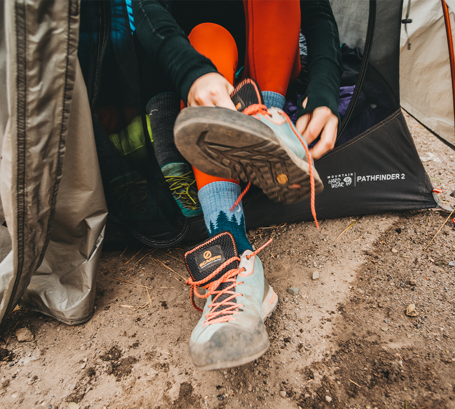 Some lucky lady in a camping tent slides muddy sneakers over fresh, fabulous socks before an adventure. Good for her.