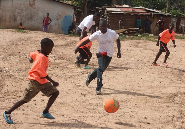 NOVICA Ghana team playing soccer with local children