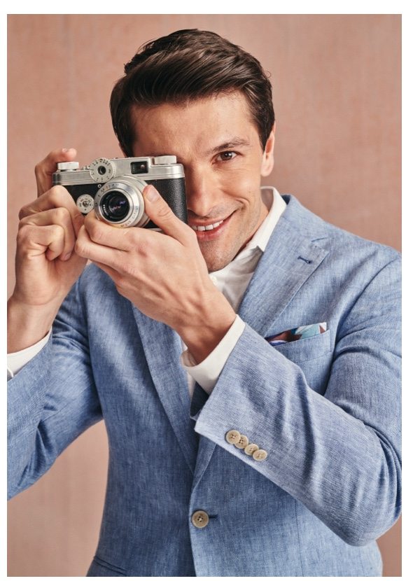 Man in blue suit taking a photo