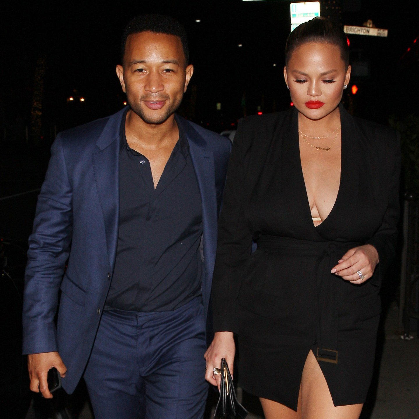 John Legend with Chrissy Teigen in a red lip.