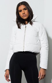 The White Out Cropped Puffer Jacket is a long sleeved, cropped puffer jacket complete with a patent vinyl exterior, zip up front and high neck collar.