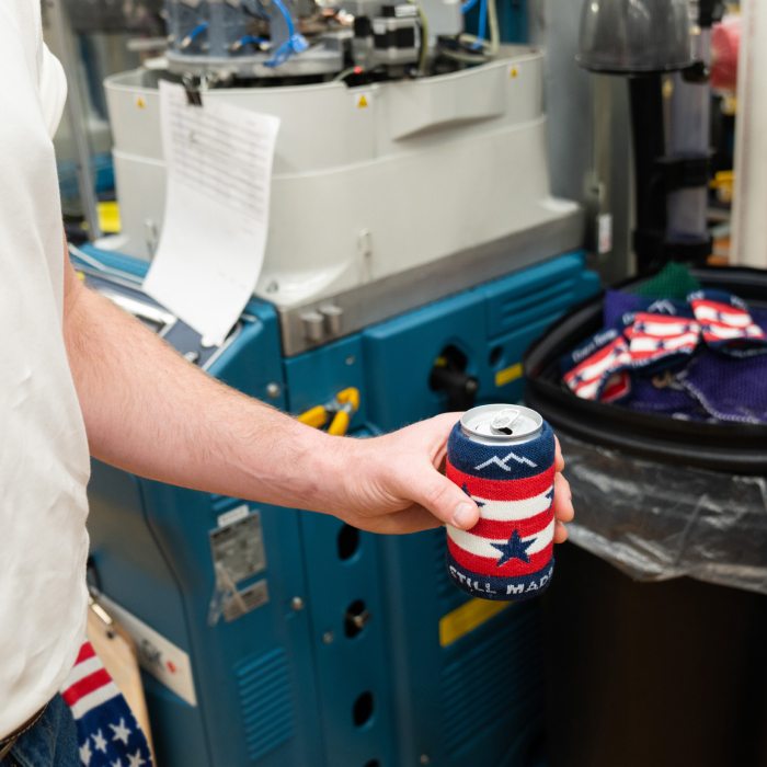 A drink can wearing the Captain Stripe Koozie, featuring red and white stripes and blue stars