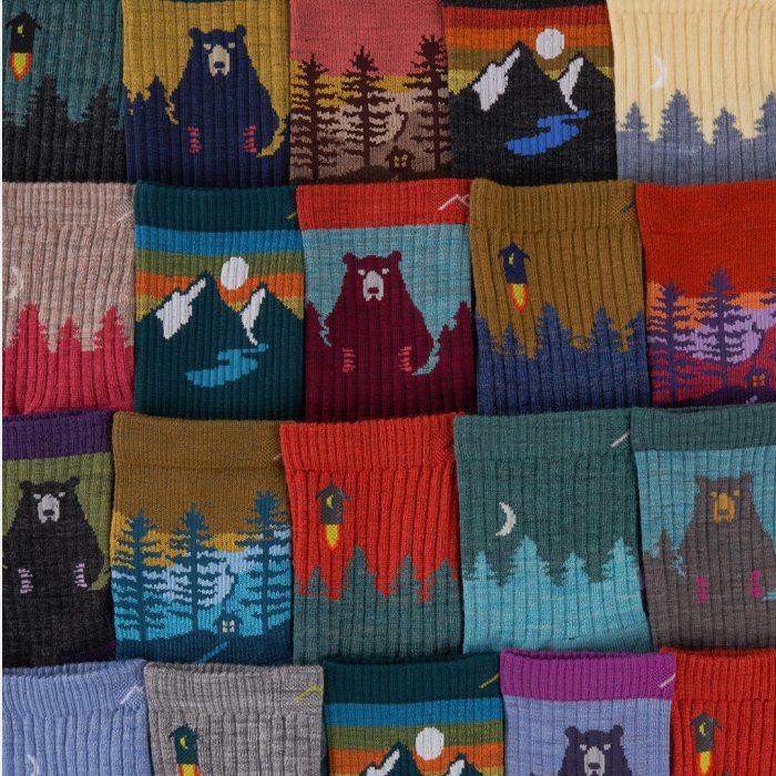 Shop Hike Socks - a spread of Darn Tough hike socks featuring bears, landscapes, sunsets, and flying outhouses