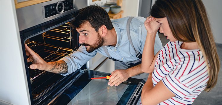 lifestyle image broken appliance and frustrated user