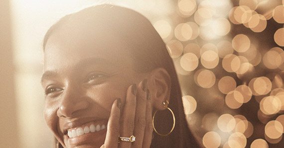 Smiling woman wearing trendy fall jewelry during the holidays