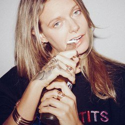 Tove Lo wears Tove Lo x Leontine jewelry while opening a beer with her teeth