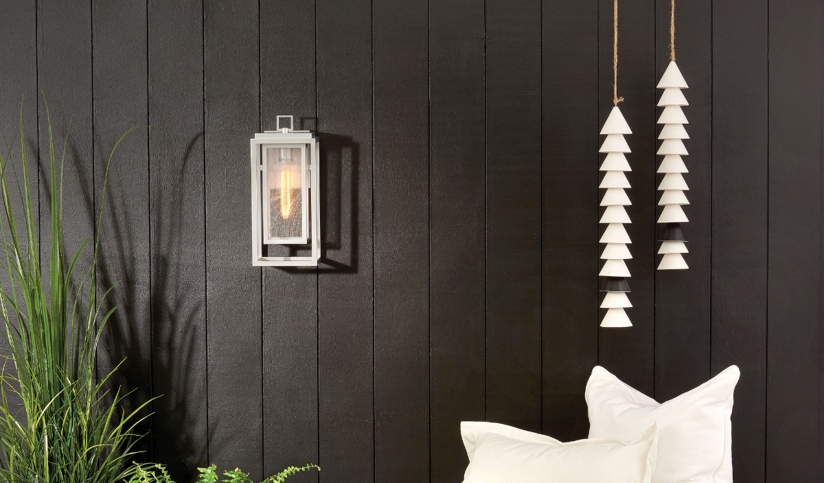 Nickel-finished outdoor light on a black wall