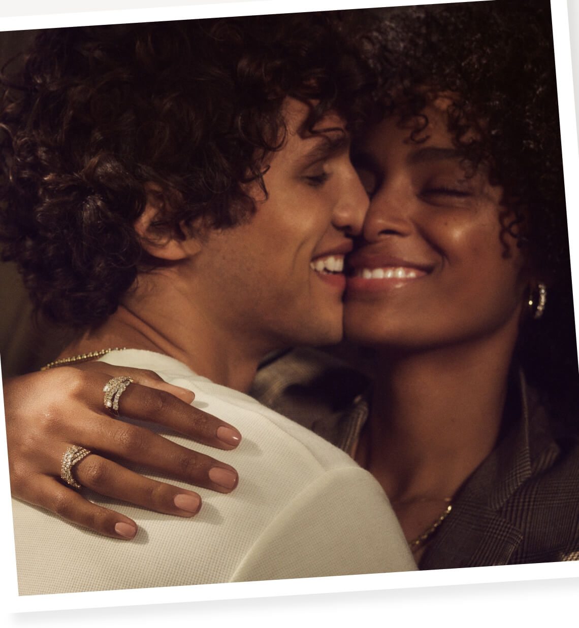 Polaroid of woman and man smiling and holding each other cheek to cheek