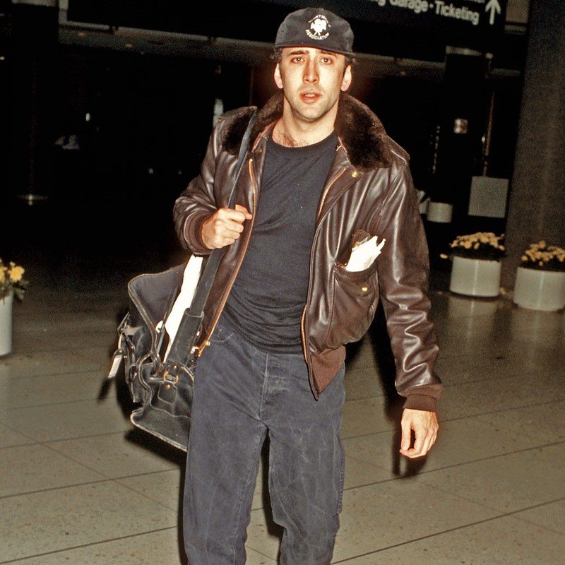 tripytch of nic cage, whitney houston, and woody harrelson in the airport in the 90s