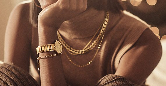 Smiling woman wearing trendy fall jewelry during the holidays