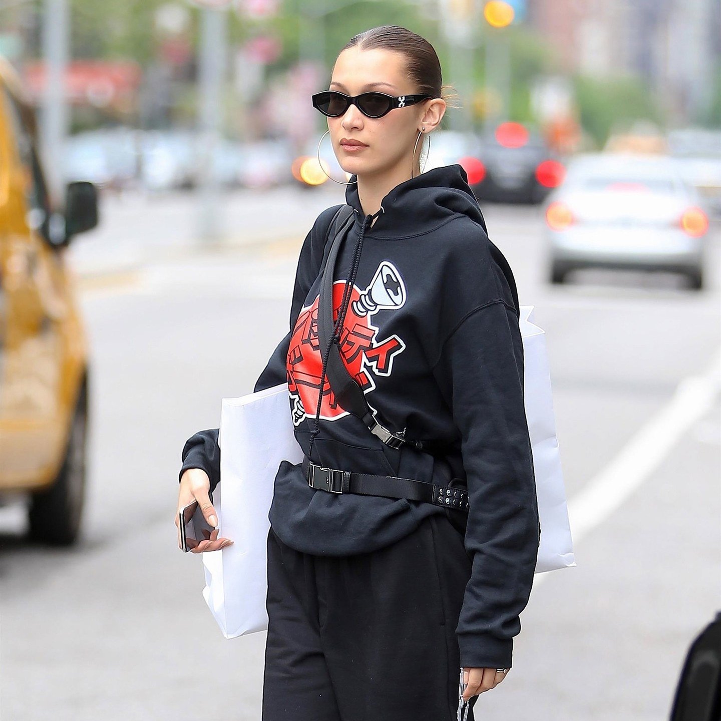 Bella Hadid pairs a slicked knot with sunglasses.