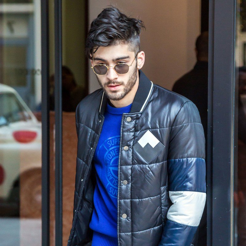 Zayn Malik pairs gelled hair with tiny sunglasses.