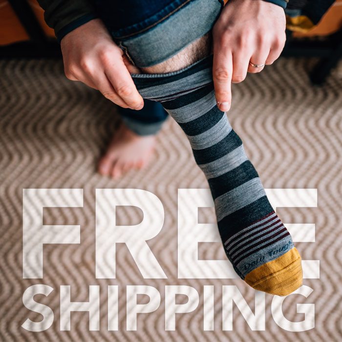 Shop with Free Shipping - a grey and black striped sock is pulled onto a foot, over the words Free Shipping