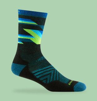 Shop Long Run Socks - a black micro crew Run sock against a green background