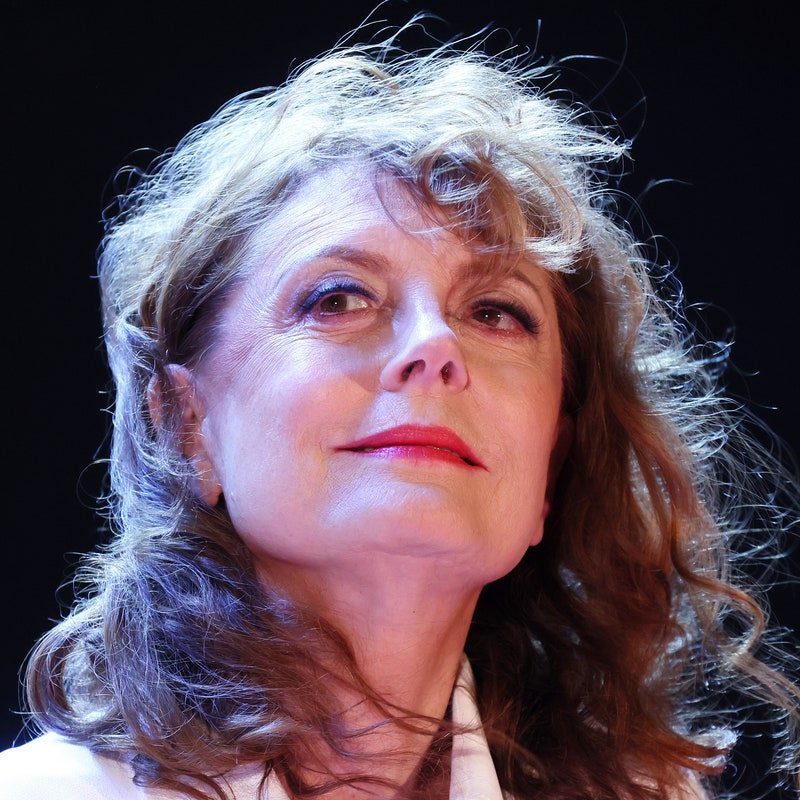 susan sarandon wearing red lisptick while her hair blows in the wind 