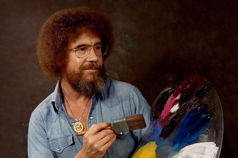 bob ross with his palette and paintbrush