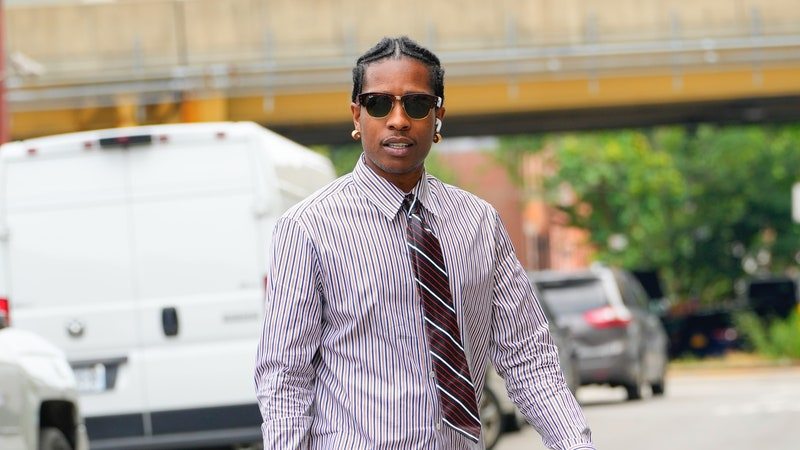 Image may contain: A$AP Rocky, Clothing, Pants, Jeans, Accessories, Formal Wear, Tie, Footwear, Shoe, Adult, and Person