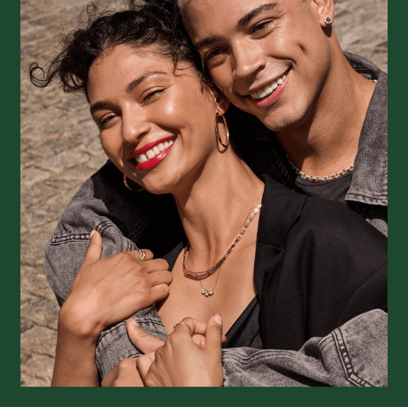  A woman joyfully hugs a man, showcasing beautiful diamond rings, Necklaces and Earrings.