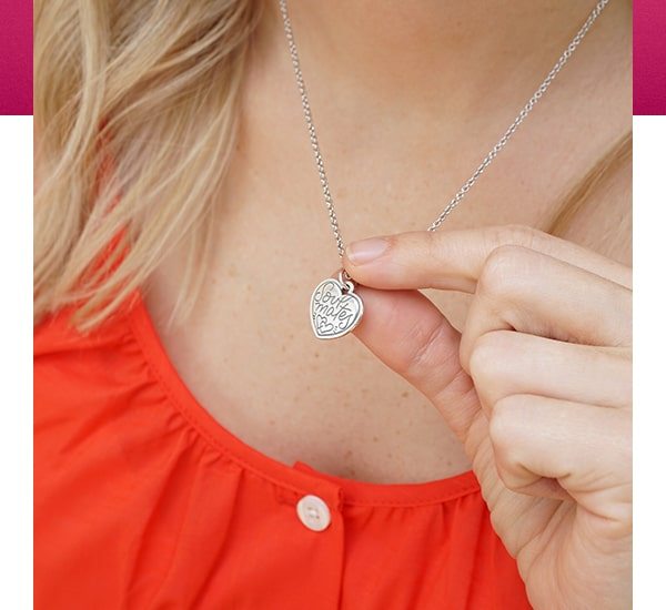 Woman showing pendant on chain