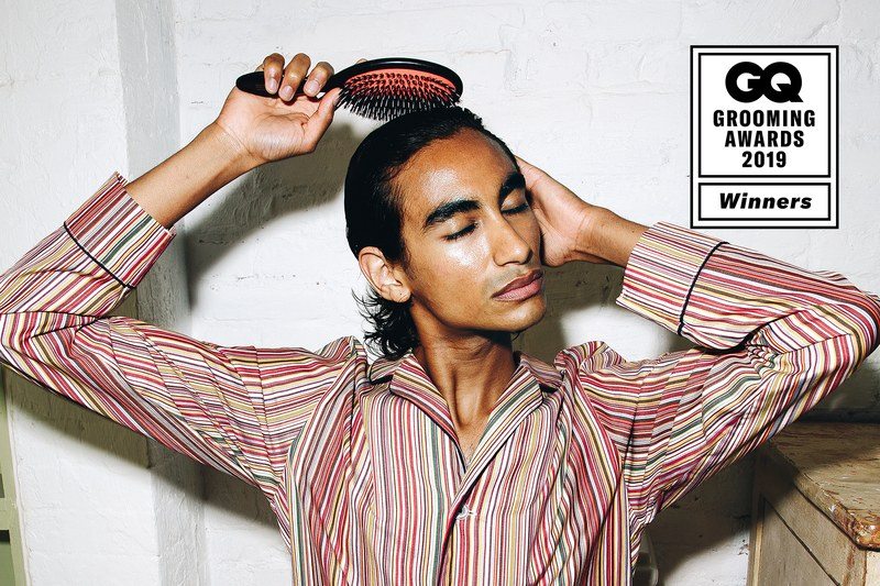 a model brushes his hair
