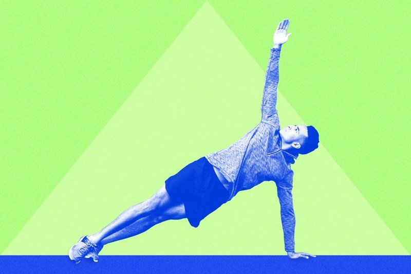 Photo of a man doing a side plank exercise on a green background