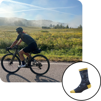 read the blog - cyclist on country road riding gravel bike with meadow in background