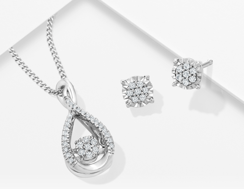 A stunning diamond necklace and a pair of diamond earrings are featured.