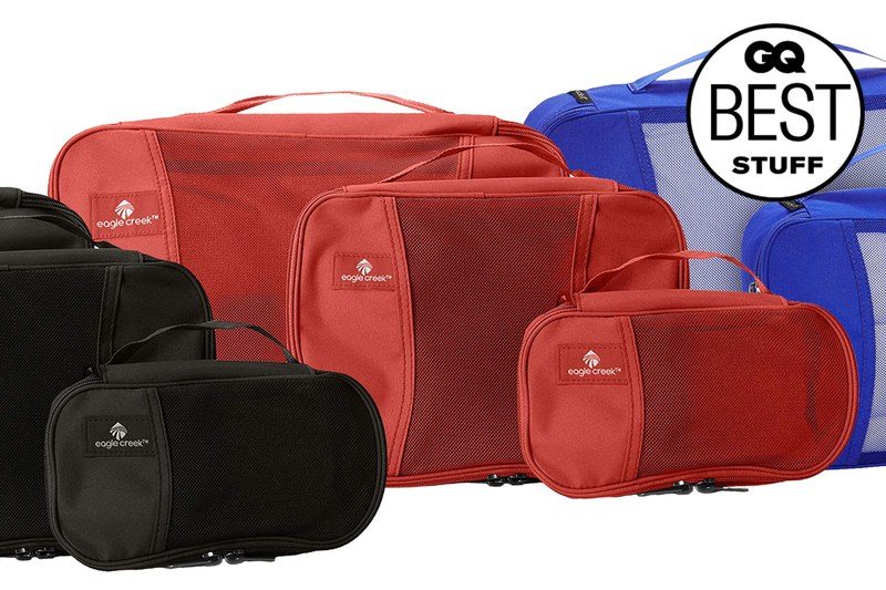 Three different colors of packing cubes stacked on top of each other