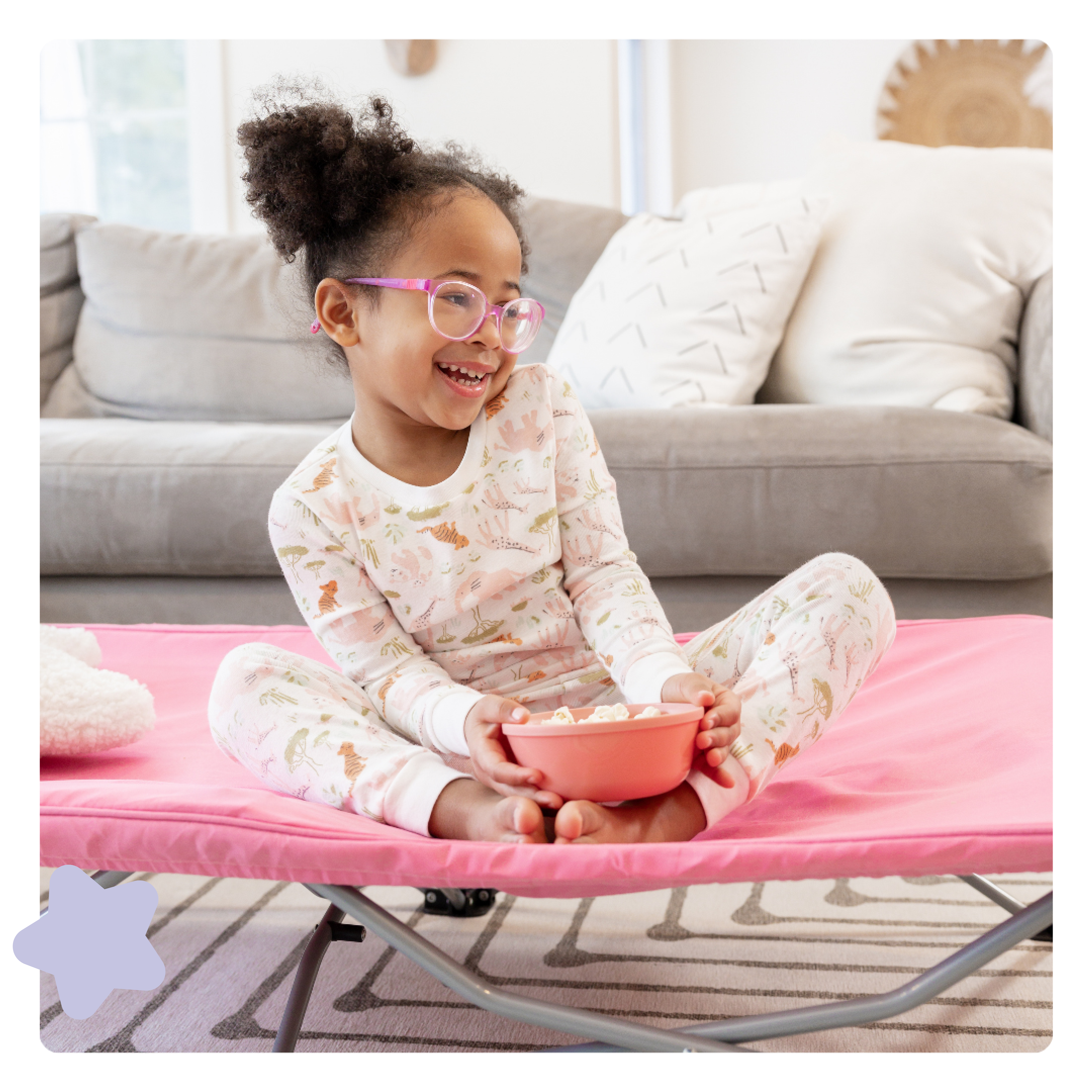 Toddler sitting on My Cot Portable Toddler Bed